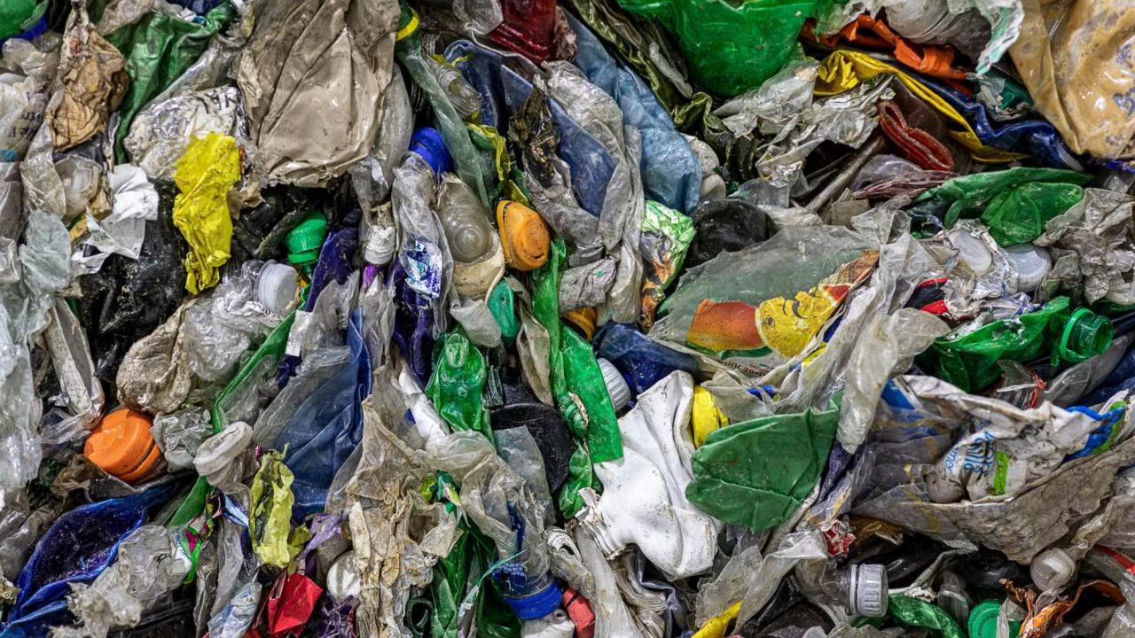 Close up of a pile of flattened plastic containers.