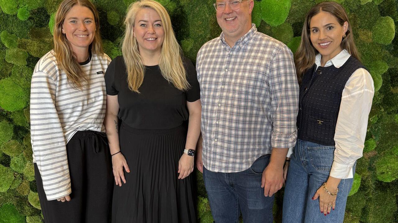 Four people standing together