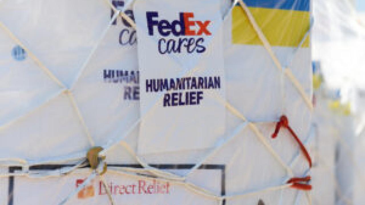close up of netted crate with a tag "FedEx cares, humanitarian relief"