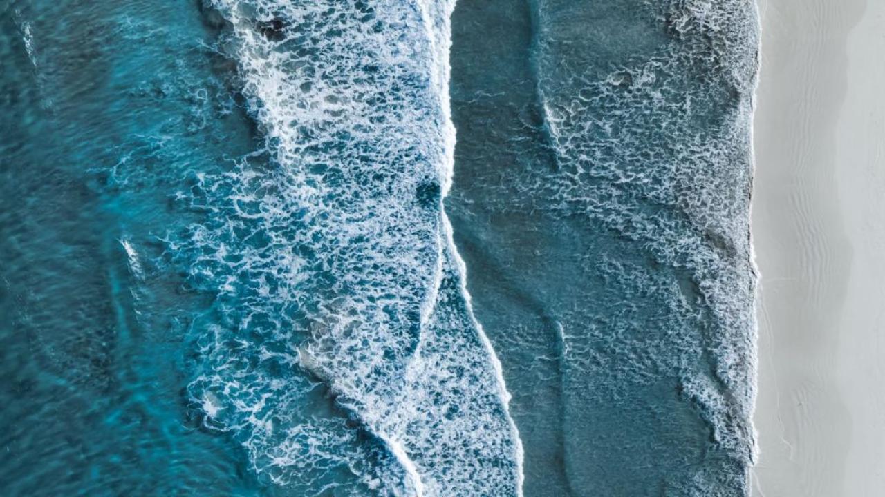 Aerial view of waves against a shoreline