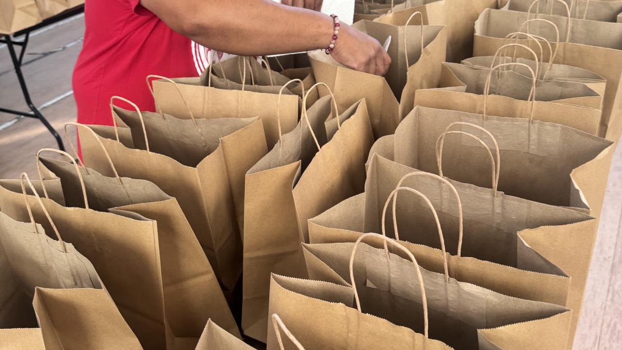 Bacardi employee filling bags
