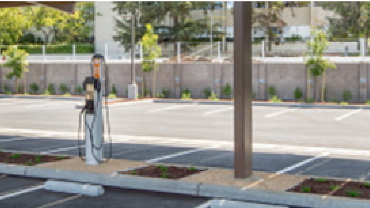 A parking lot with multiple EV charging stations.