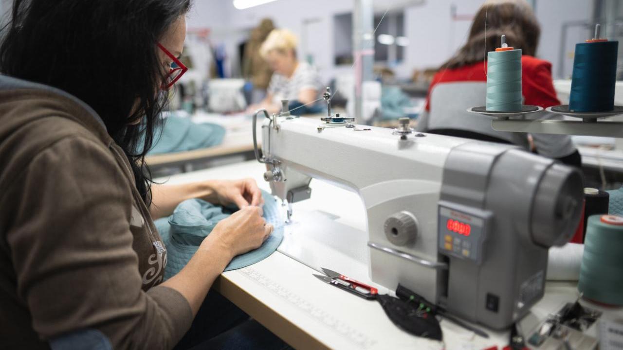 apparel factory worker at sewing machine