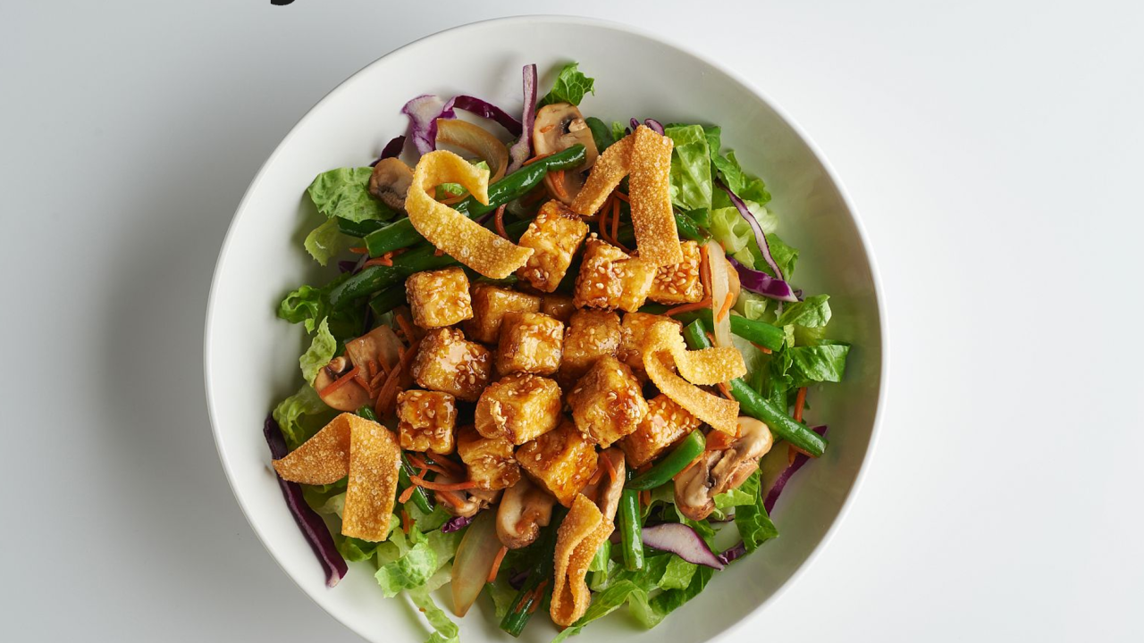 Bowl of California taco salad with Cool Food Meals logo at the top left