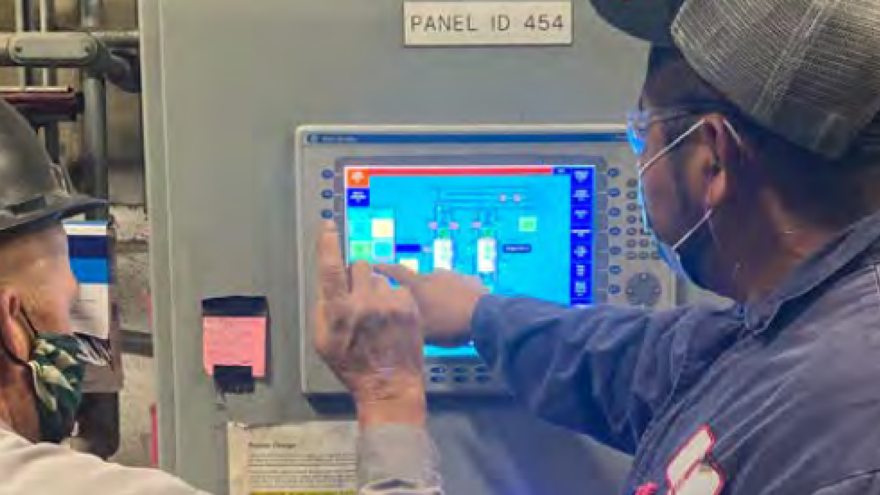 Rodney Ivy and Margarito Barreto at the Houston plant pointing to screen