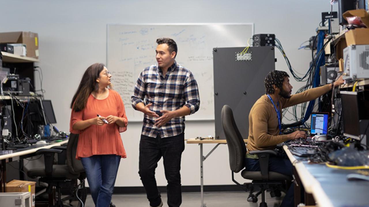 three people in a computer lab