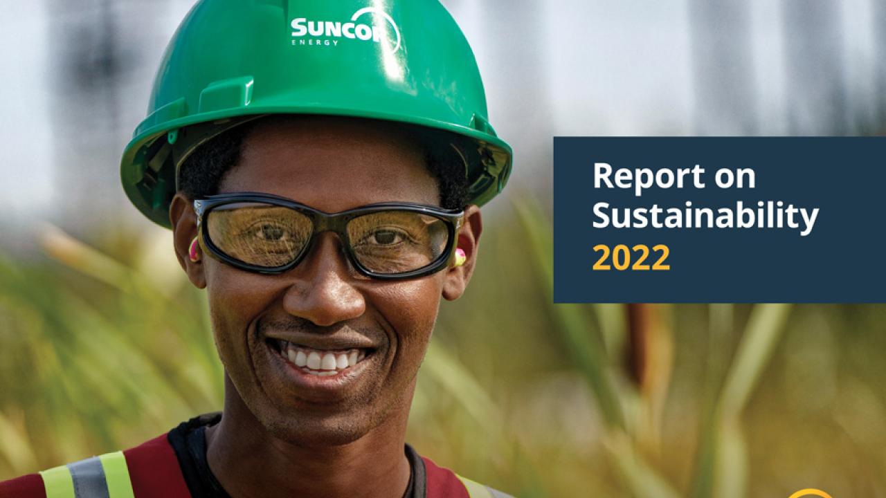 Suncor report on Sustainability 2022 with smiling person wearing a hardhat
