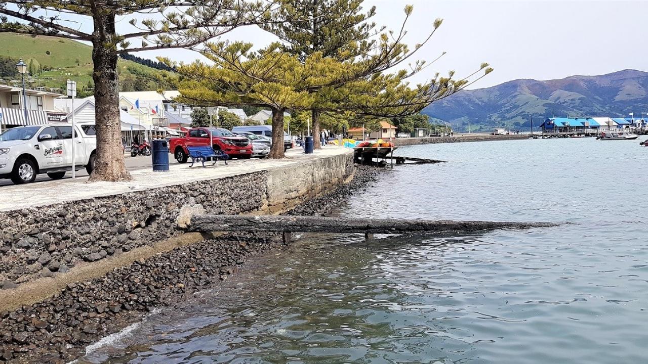 Seawall with mountains in background