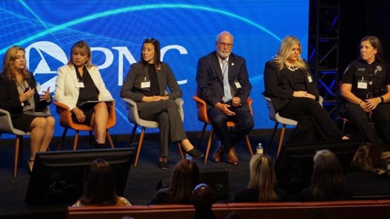 Six panelists on stage with PNC logo behind them