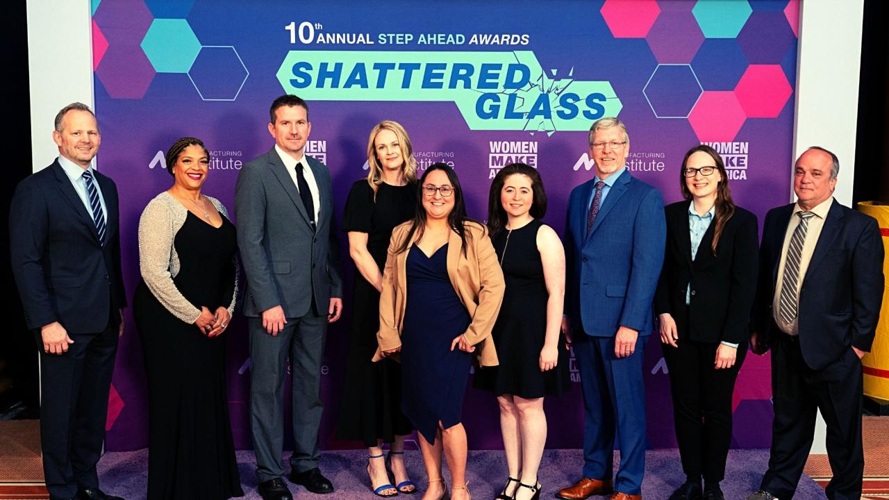 People Standing in front of a "Step Ahead Awards, Shattered Glass" Background