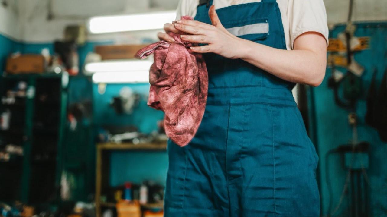 person cleaning their hands in a shop