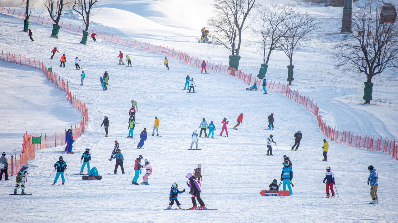 People skiing down a slope