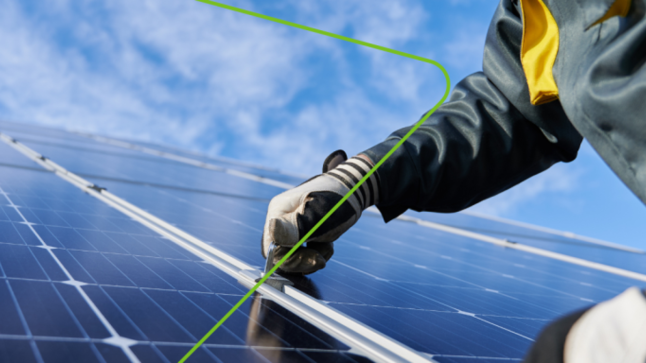 Close up of a person installing a solar panel.