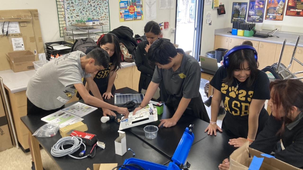 A team of students working on solar battery kit.