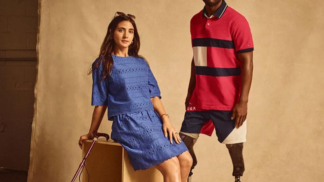 A female model with a cane and a male model with prosthetic legs.