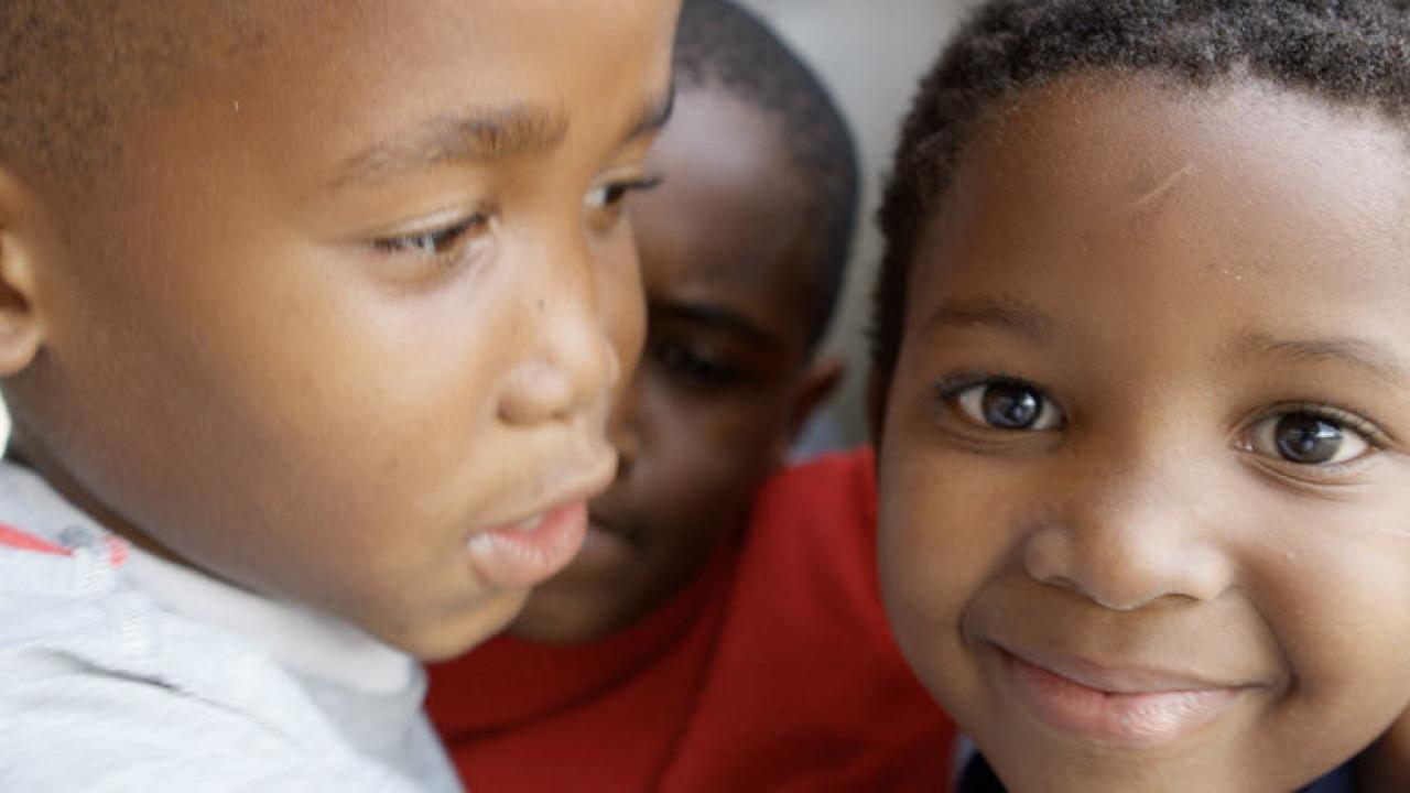 Three children embracing each other