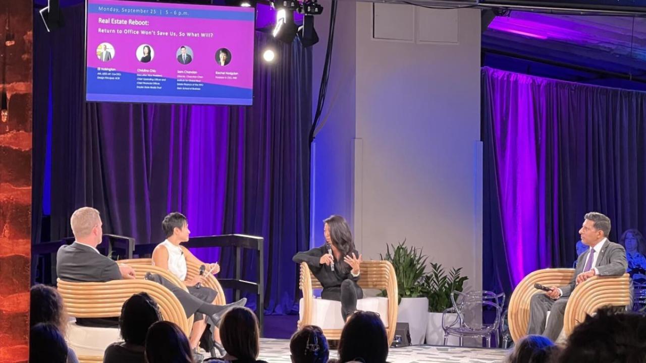 Four people having a discussion on stage