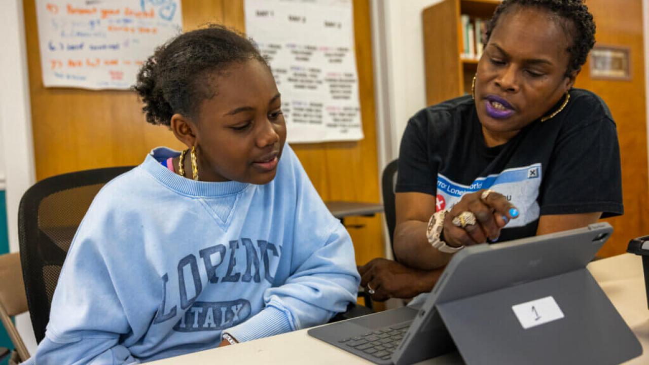 A teacher working with a student