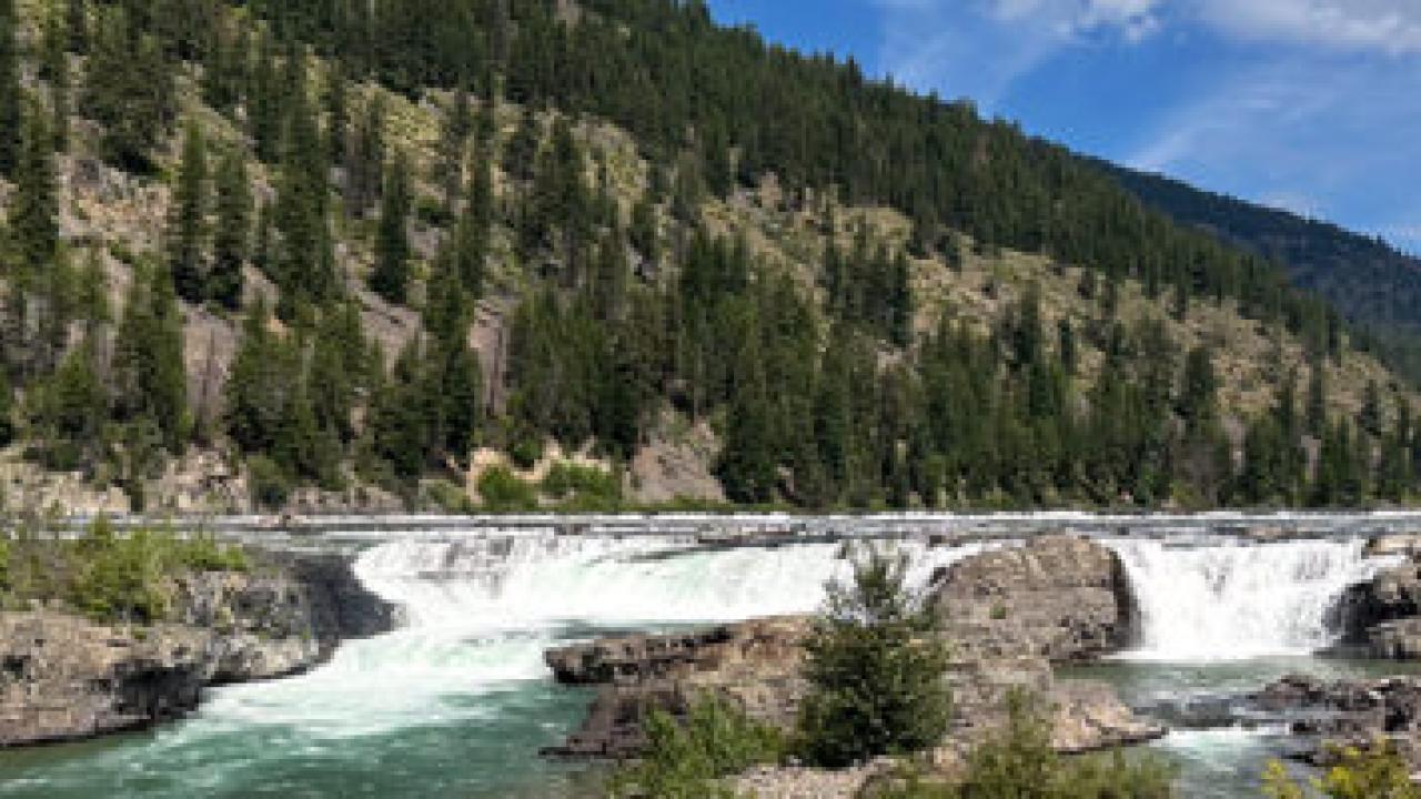 A river running next to a mountain