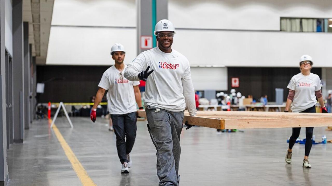 volunteers carrying things and smiling