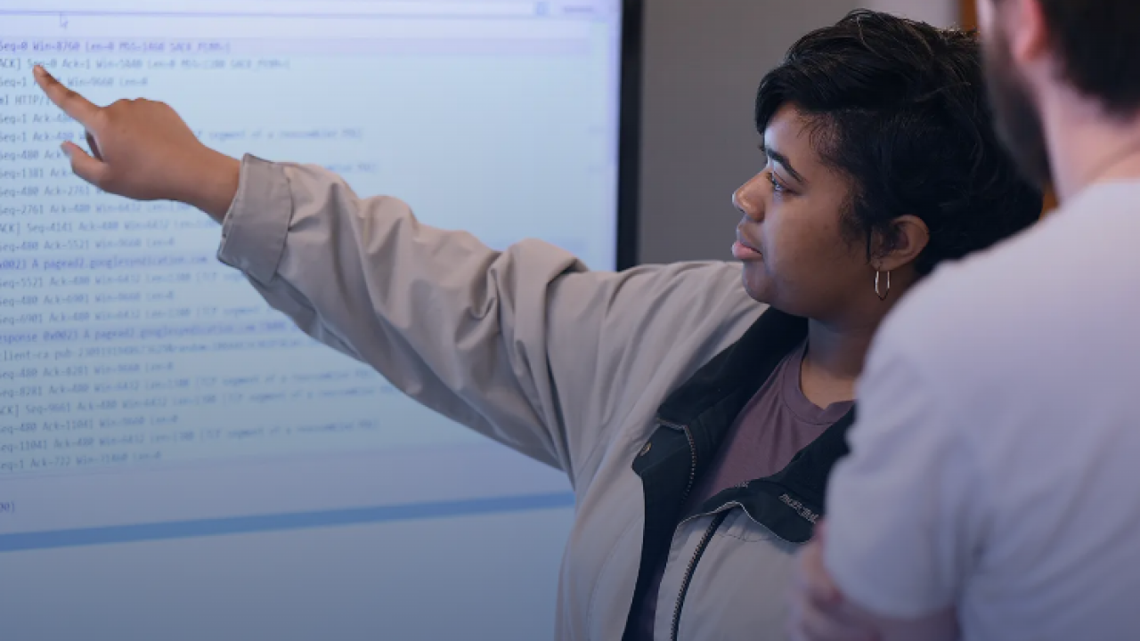 students working on a large screen