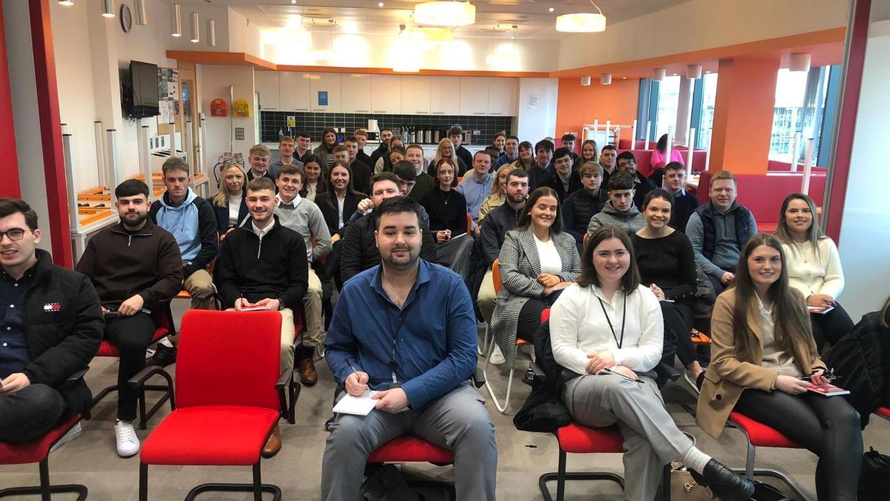 A room full of seated students and staff.