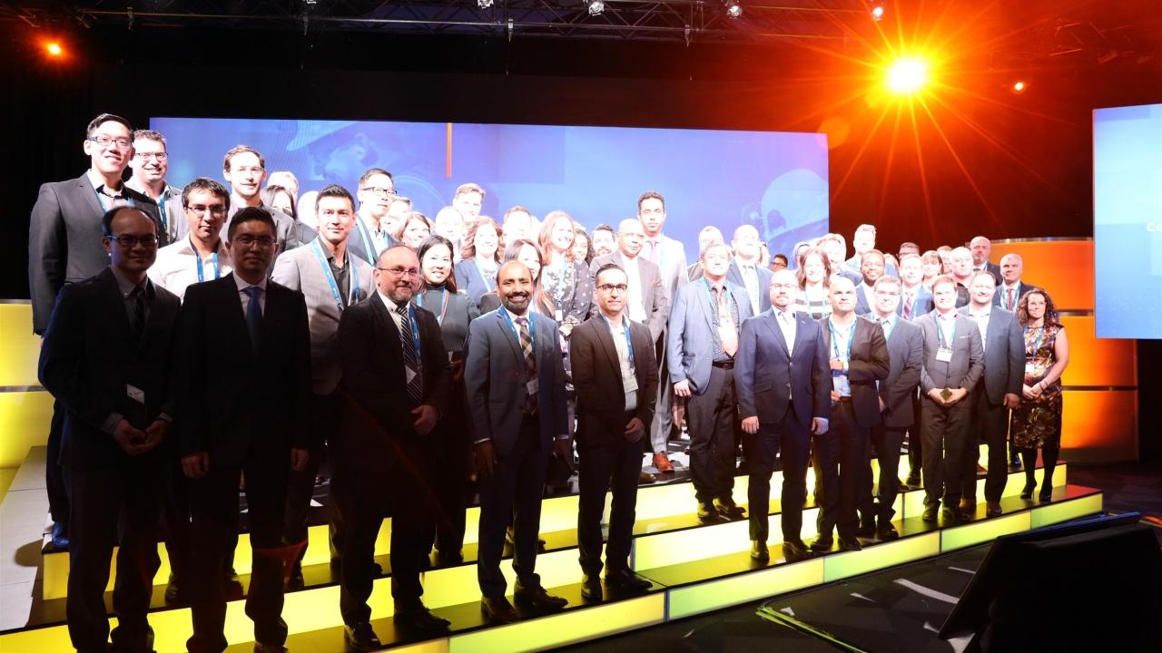 Suncor employees standing on a stage, wearing medals