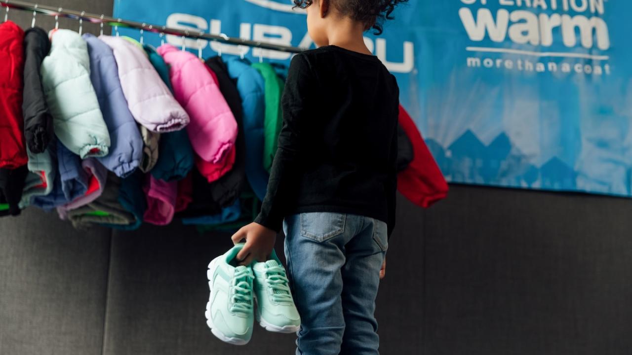 child looking at new clothes