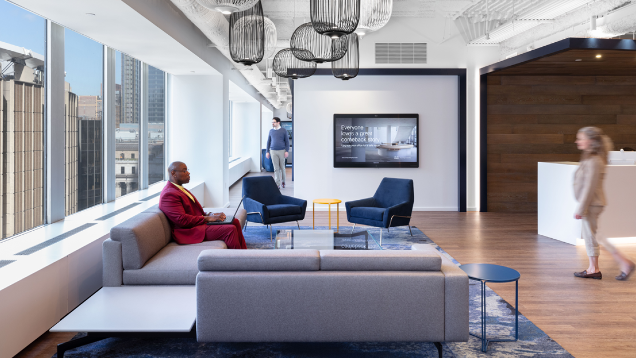 People inside office space with chairs and couches