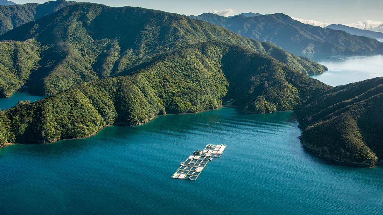 boats in water surrounded by mountains