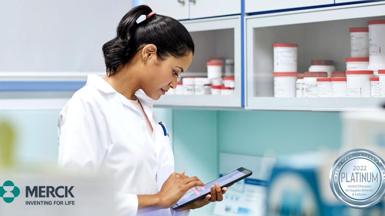 Woman in lab coat on tablet