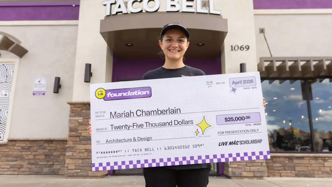 Mariah Chamberlain holding an oversized check