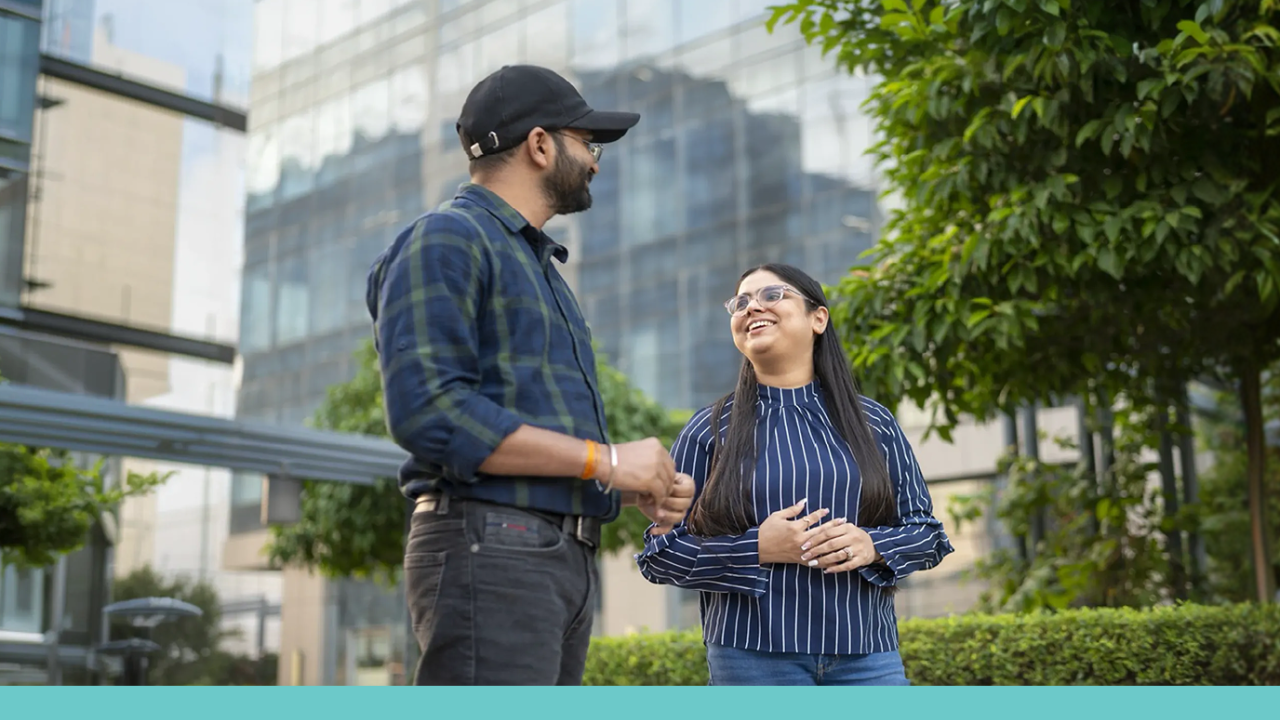 Two workers speaking outside an office building
