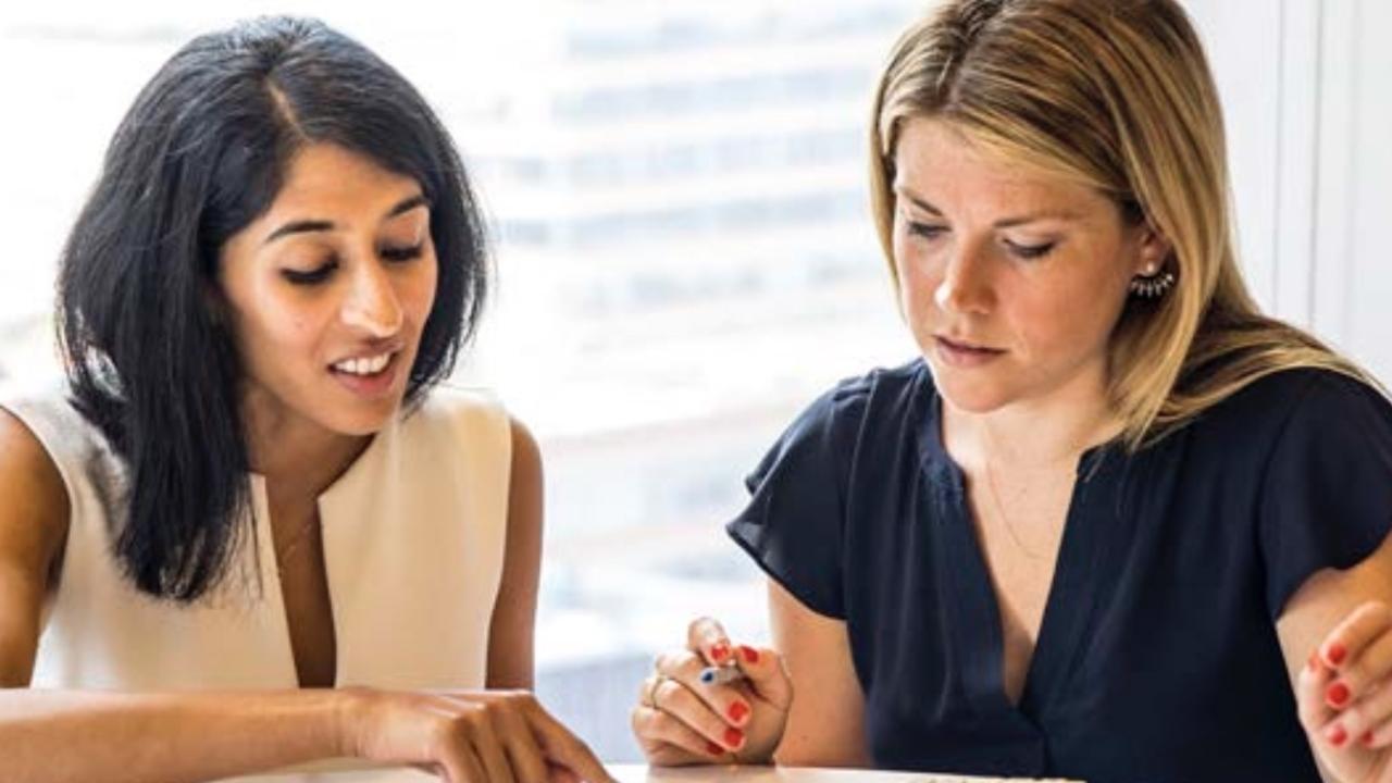 Tapestry employees collaborating at a round table