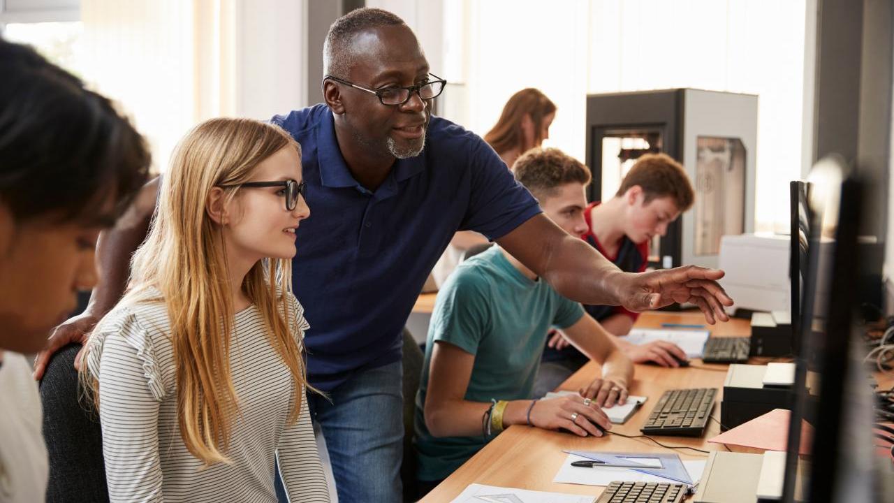 teacher and students on computers