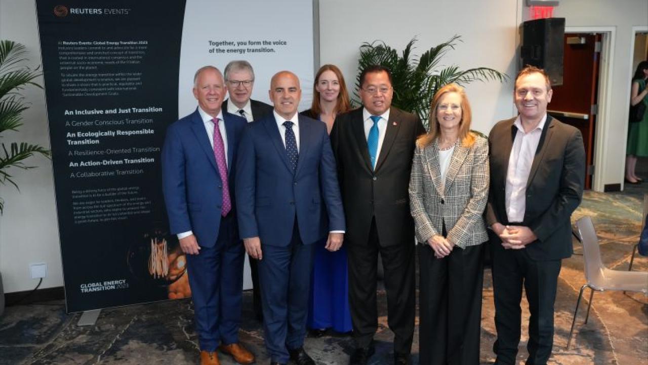 A team of people posed in an open room.