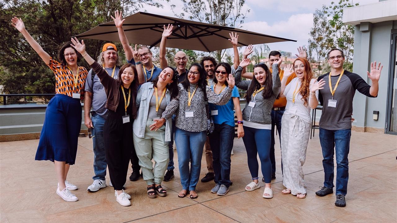 Group of volunteers outdoors waiving