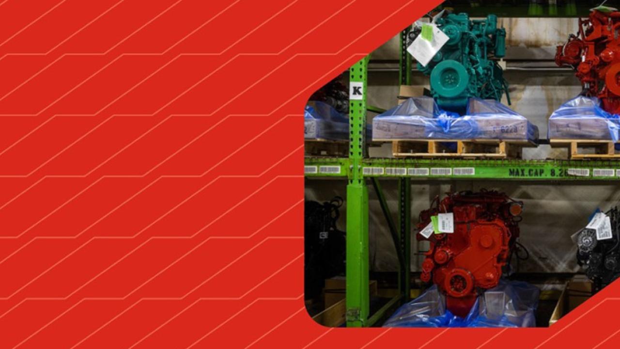 Painted engines neatly placed on shelves. On the left a red pattern background.