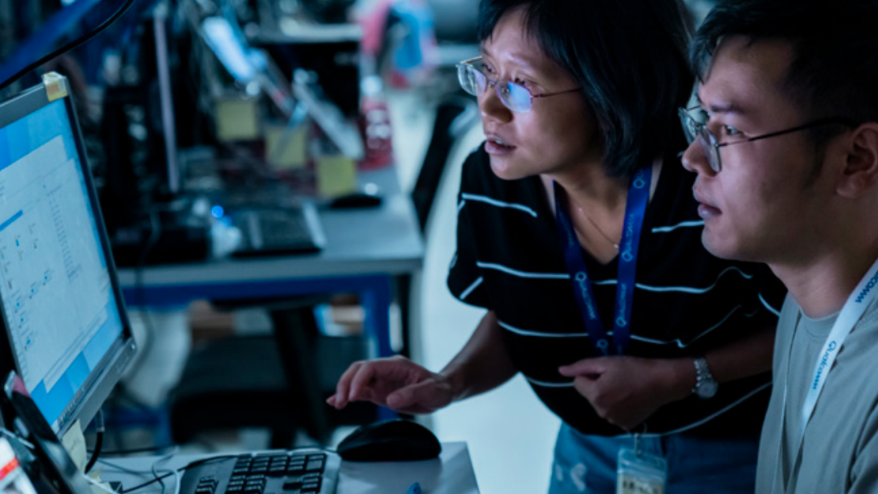 Two people looking at the same computer screen.