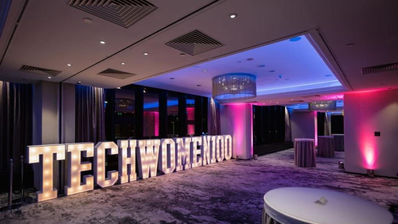 A large lighted sign reading TECHWOMEN100