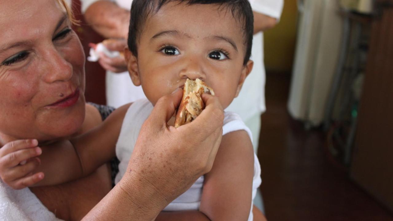 woman feeding baby food