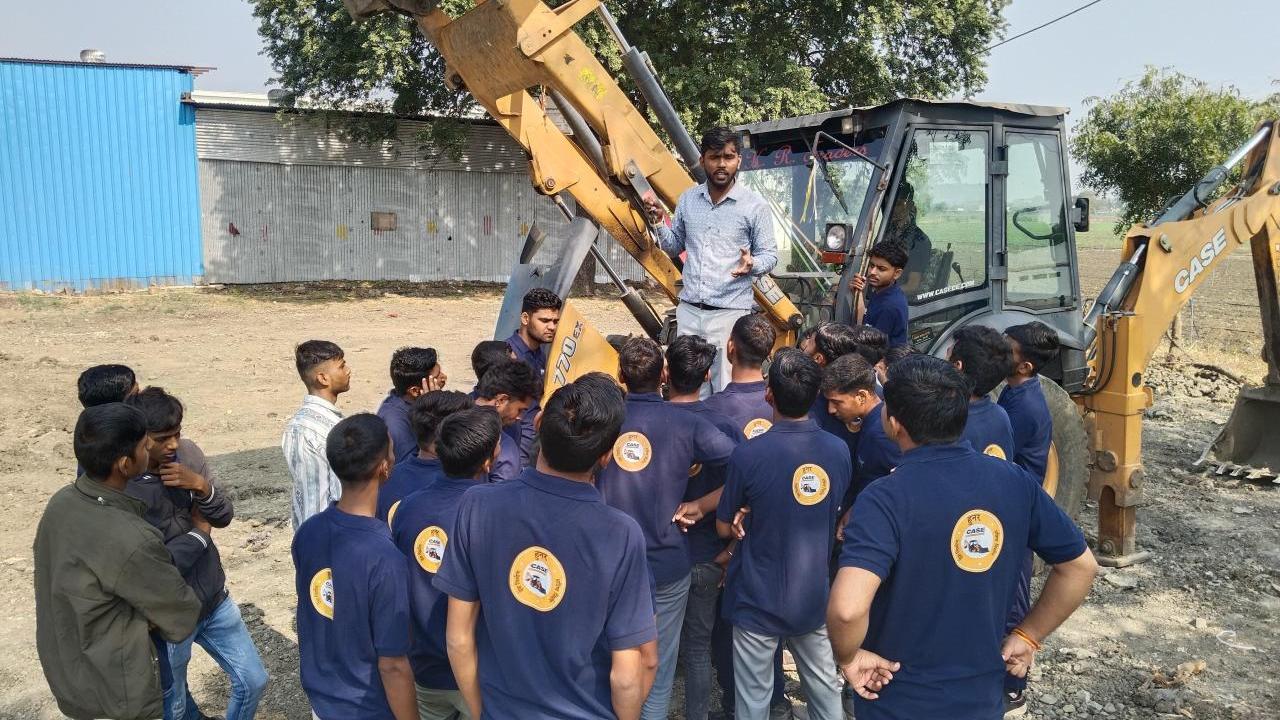A group of students around farm machinery