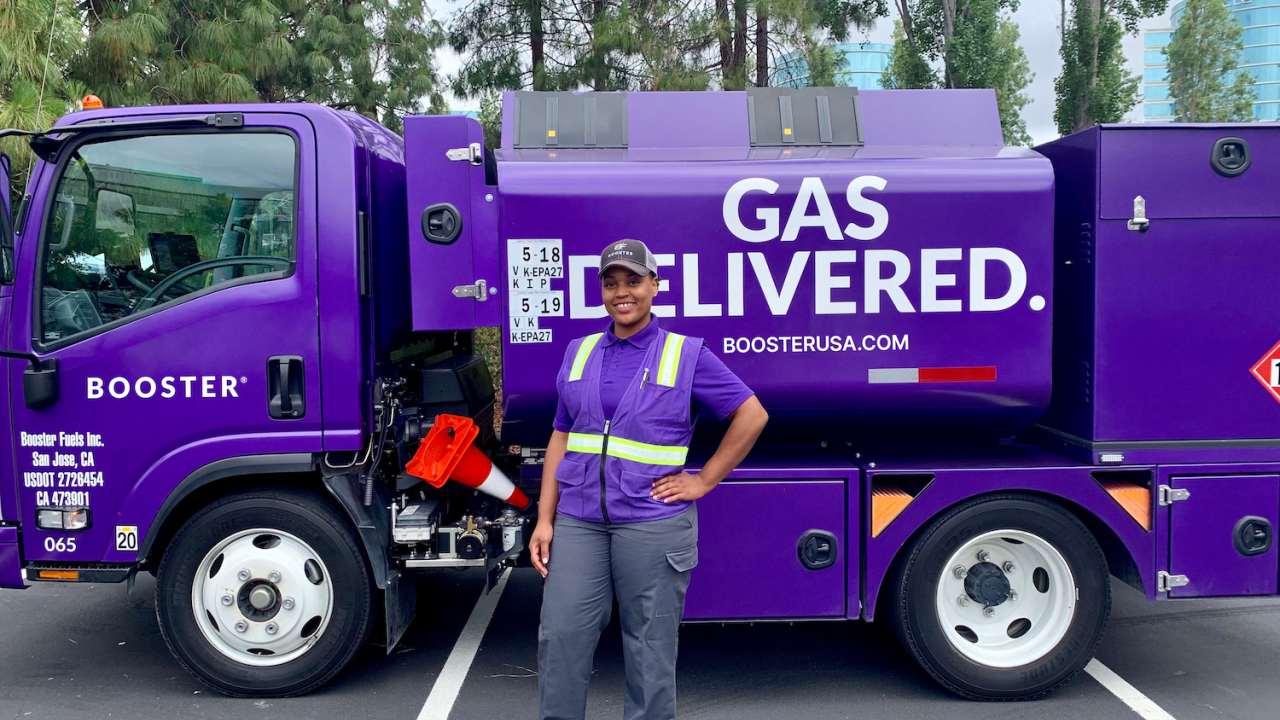 Booster Fuels driver standing in front of truck