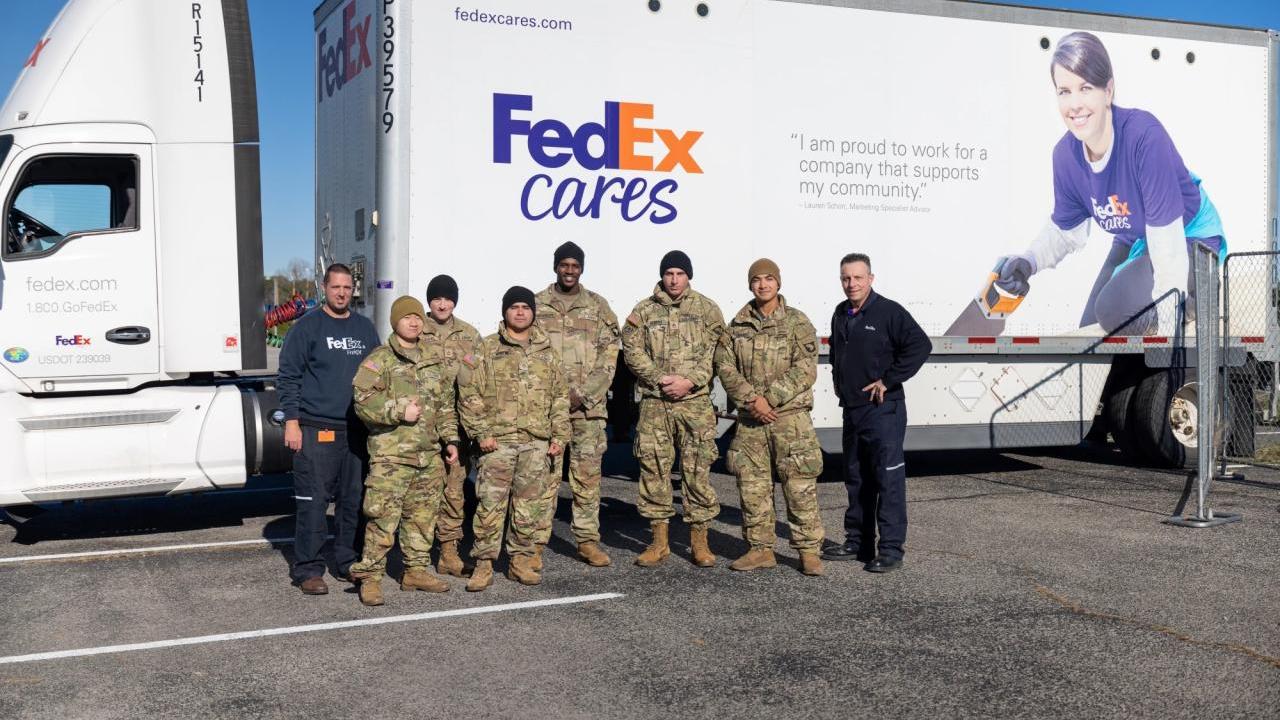 Group photo in front of FedEx Cares truck