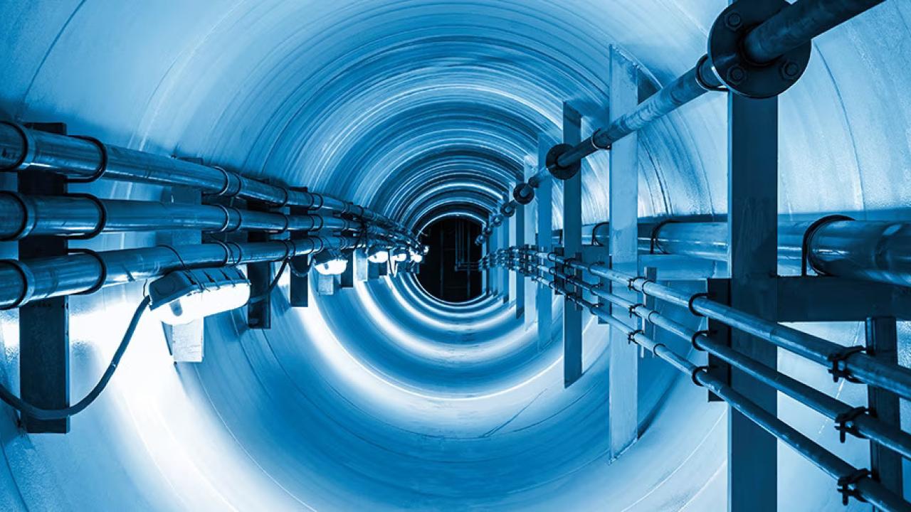 A tunnel with groups of long wires bundled on the sides.