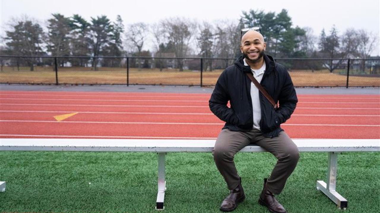person sitting on a bench at a track