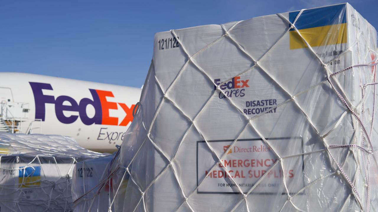 FedEx plane with cargo in front