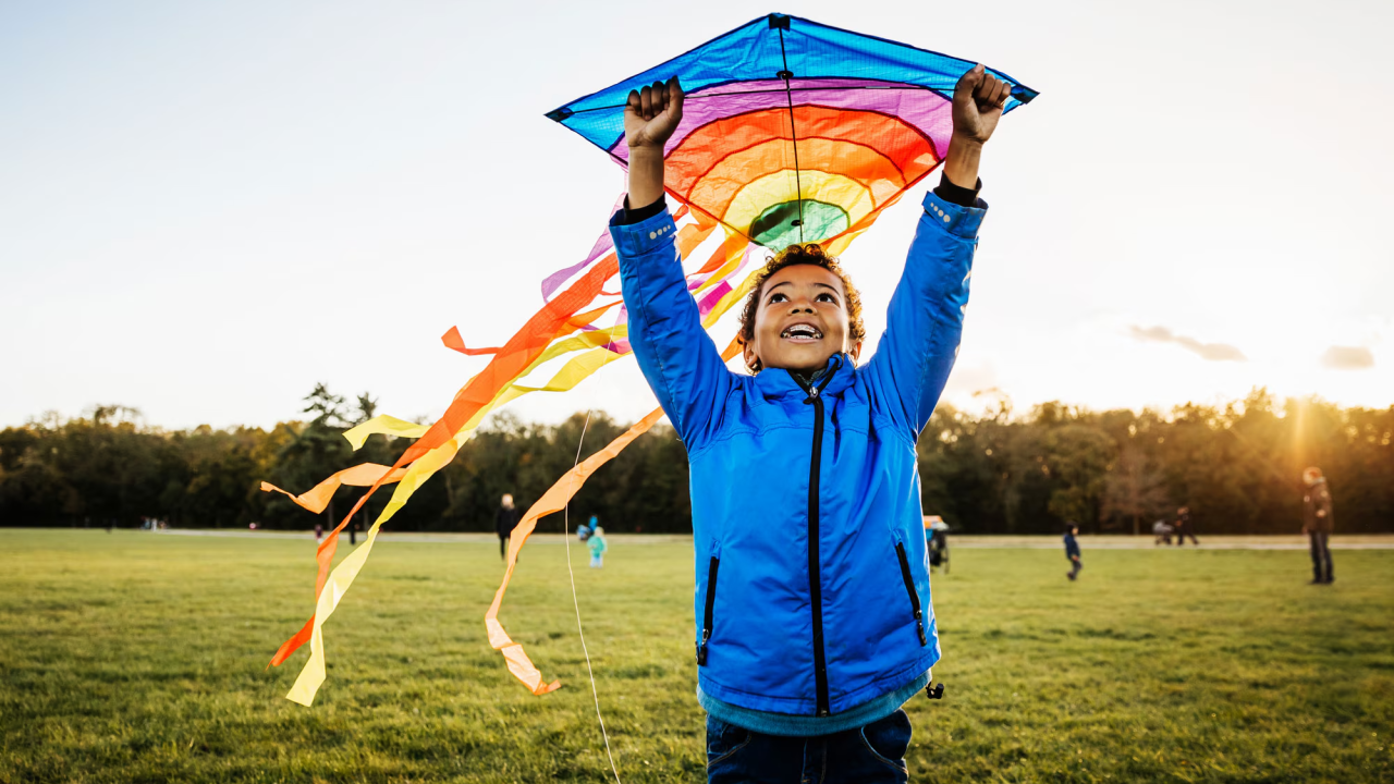 A child holding a colorful kite