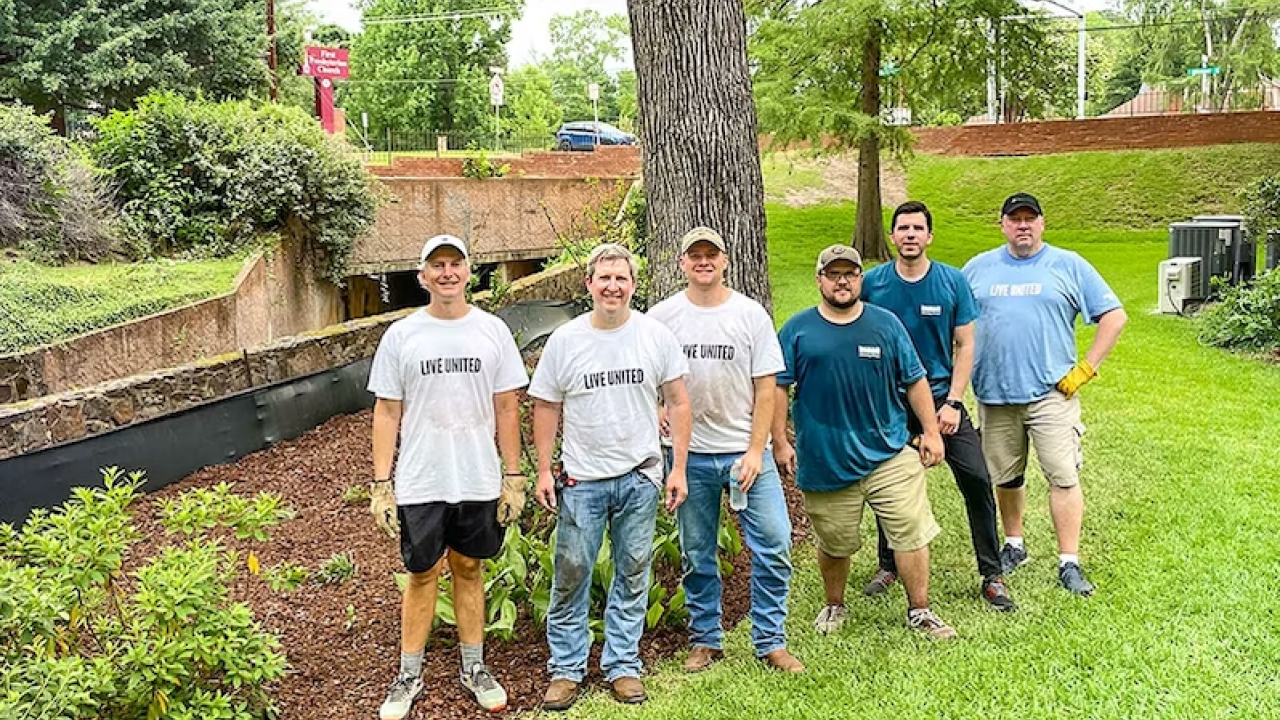 Six volunteers standing outside