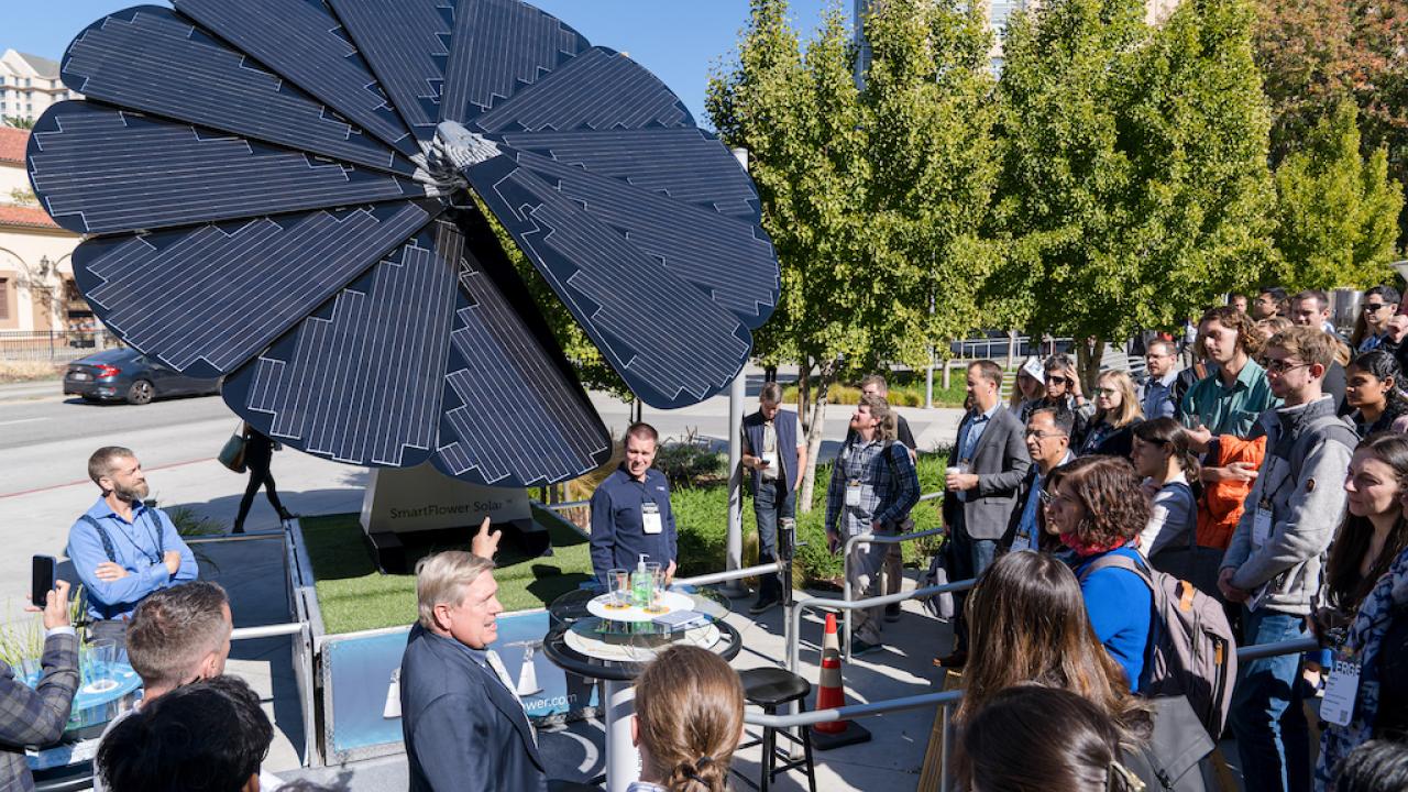 People stood looking at the SmartFlower Solar